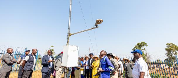 People standing in front of an automated weather station